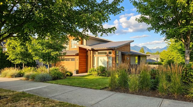 Contemporary West Coast home in Walnut Grove, Langley, BC — summer exterior with ornamental grasses and Golden Ears mountains, photographed for AG. Song REALTOR®